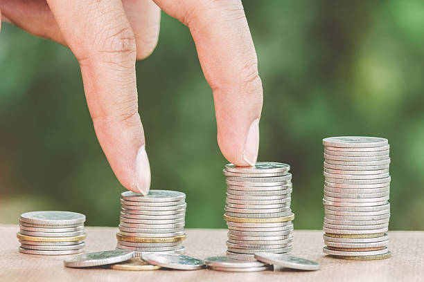 istock Male hand steps on money coin like stack growing business 610663386