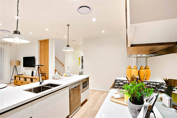 istock Modern kitchen closeup with white walls and hanging lamps 610665488