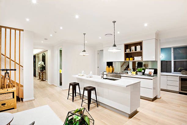 modern kitchen with white walls illuminated by hanging lamps - ceiling imagens e fotografias de stock