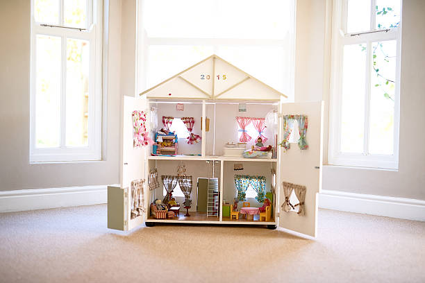 The dolls' home Shot of a dollhouse in an empty room model house stock pictures, royalty-free photos & images