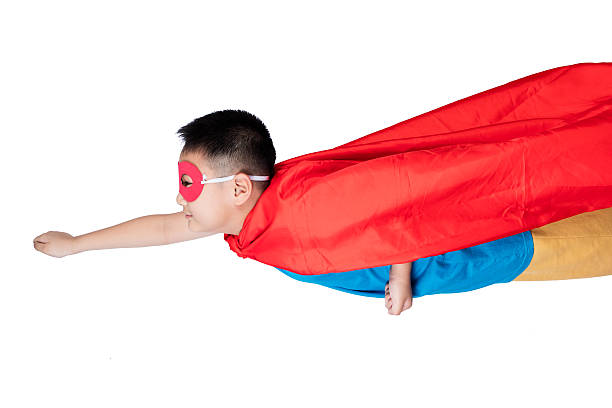 Asian Chinese boy wearing super hero costume in isolated white background.