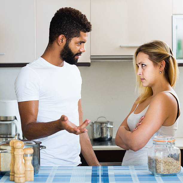 istock interracial family couple with serious faces quarrelling in kitc 610667784