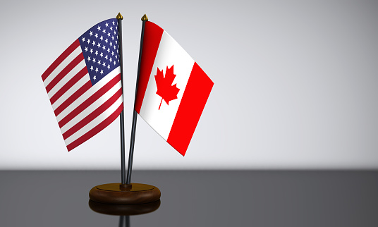 US flag and Canadian desk flags 3D illustration.