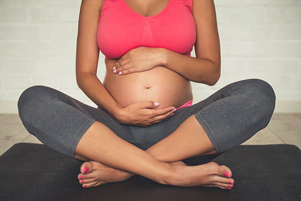 istock Pregnant woman doing yoga 610668914