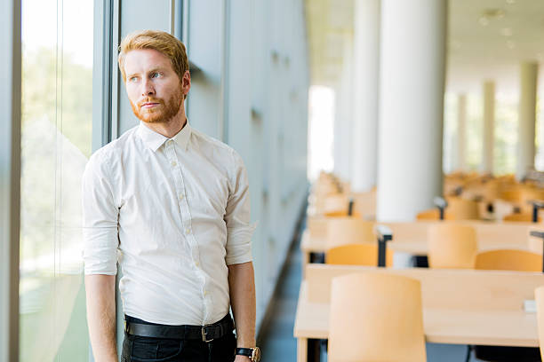 istock Successful businessman standing by the window 610669410