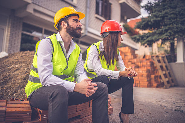 istock Architects sitting in front of a construction site 610671580