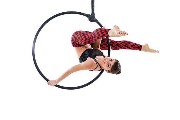 istock Woman hanging in aerial ring, isolated on white 610672190