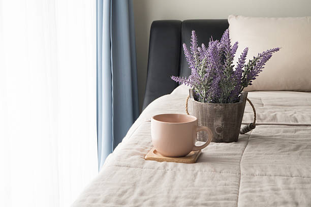 istock bed with lavender flower and coffee cup in the morning. 610672626