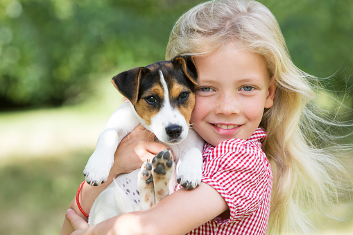 Portrait Of Girl Holding Pet Dog