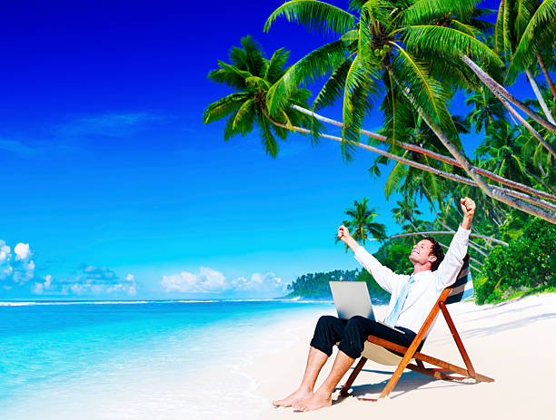 istock Businessman Relaxing Idyllic Palm Fringed Beach Concept 610673836