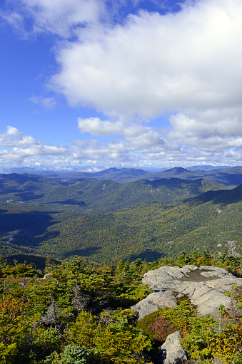 Alpine view from summit of a 46er with vast forests clouds and wilderness in the Adirondack Mountains, New York State