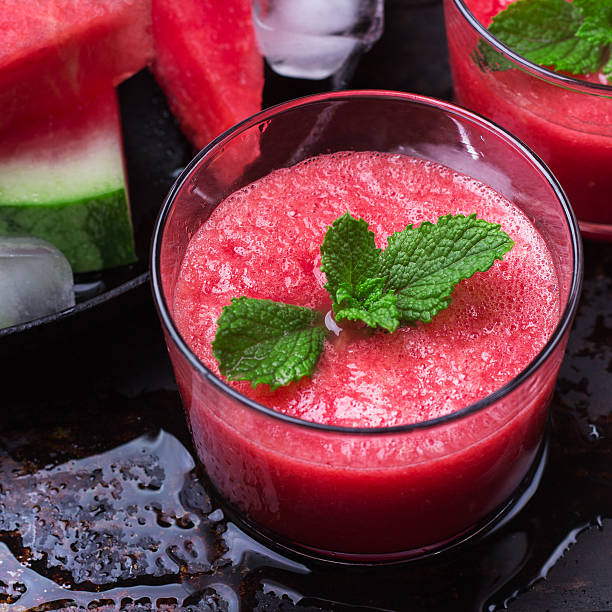 istock Watermelon slices drink smoothie with mint on grunge table 610675246