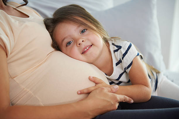 istock Woman embracing her two children 610675688