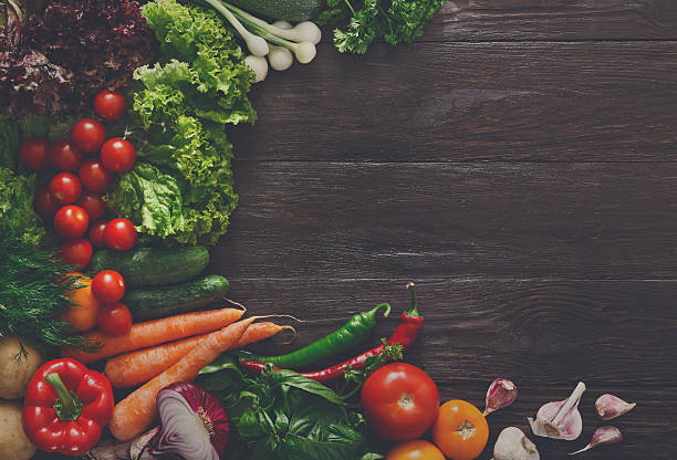 istock Border of fresh vegetables on wooden background with copy space 610675700