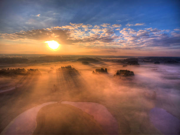 Aerial view over a golf course in Sweden. Morning fog at sunrise.