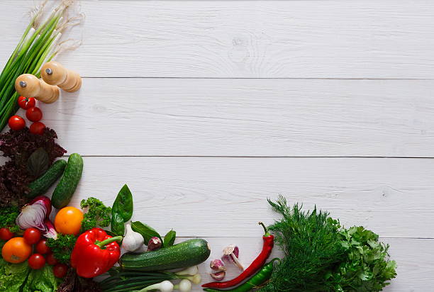 istock Fresh vegetables border on white wood background with copy space 610676120
