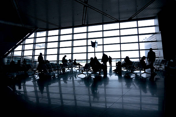 istock Silhouettes of people in modern hall 610676972