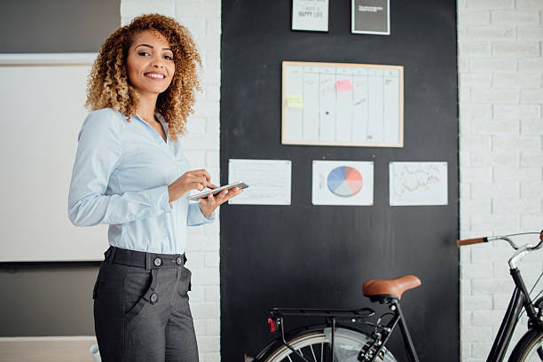 istock Latina Businesswoman Using Digital Tablet In Her Office. 610677236