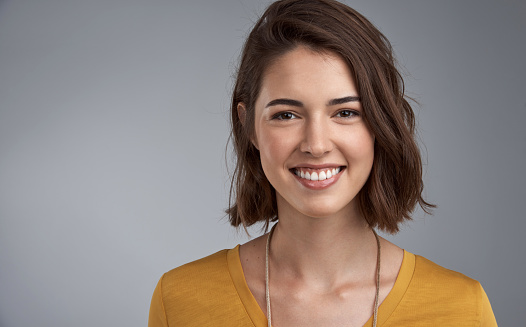 A smiling beautiful casually dressed Caucasian female relaxing at home.