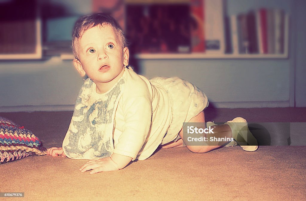 vintage cute baby boy Vintage photo of a baby boy crawling at home. Photography Stock Photo