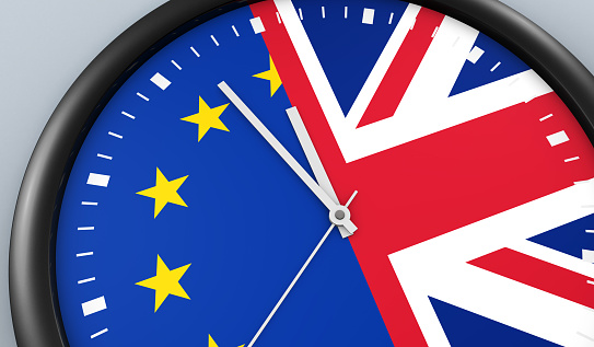 Brexit UK exit from EU negotiation process concept with Union Jack and European Union flag on a clock 3D illustration.