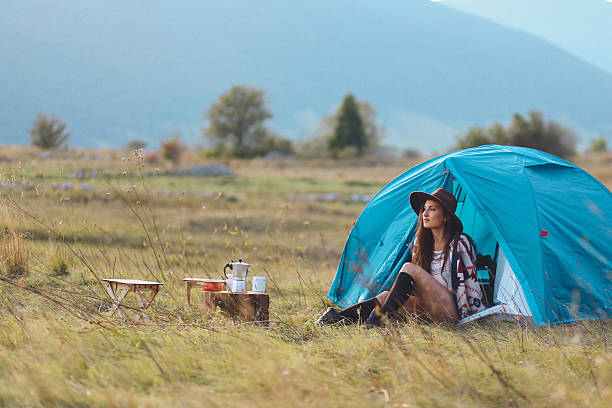istock Young woman camping in a tent 610682586