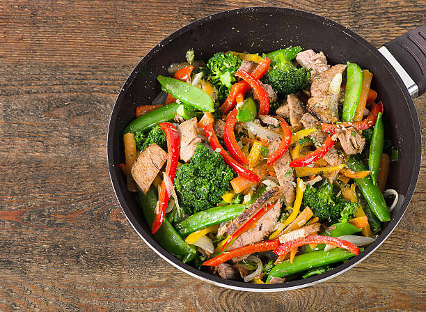 istock Beef vegetables stir fry on wooden table. 610684094