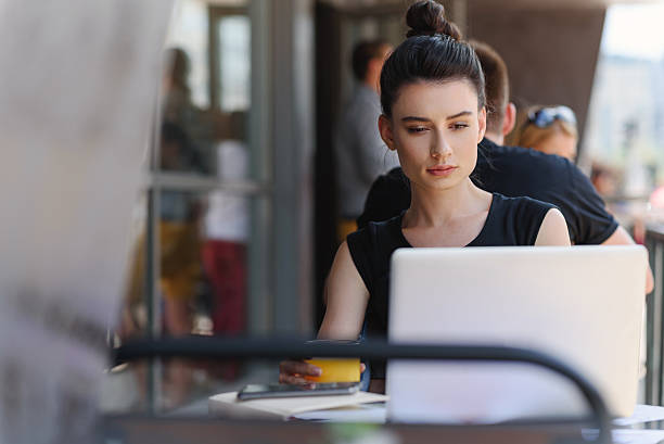 istock satisfied female freelancer sitting in front of a laptop 610684364
