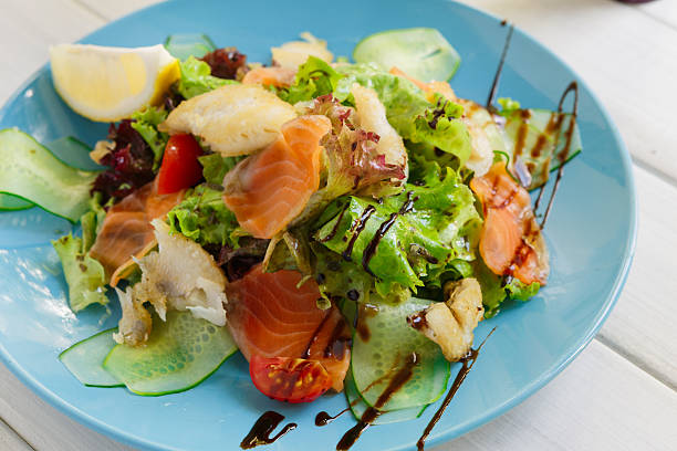 istock Healthy restaurant food, salmon and cod fish salad closeup 610684694