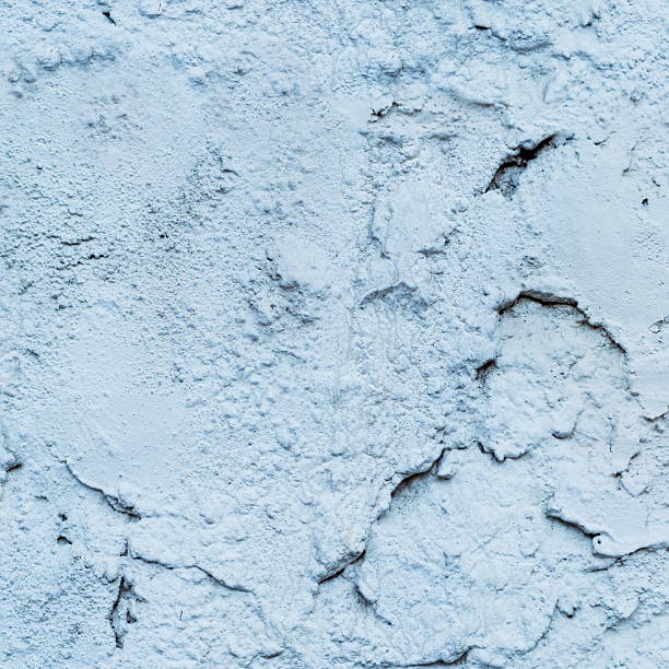 istock Gray plaster weathered wall with stains and cracks 610686110