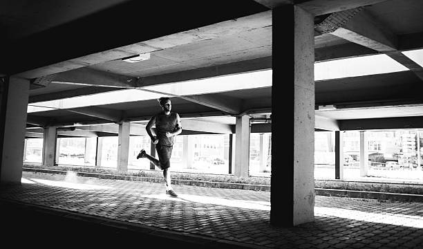 istock black and white photo of a man running 610686670