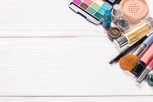 istock Various makeup products on wooden background with copyspace 610688682