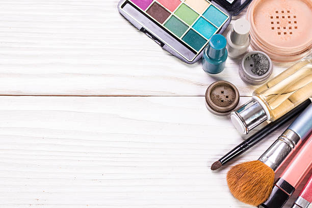 istock Various makeup products on wooden background with copyspace 610688716