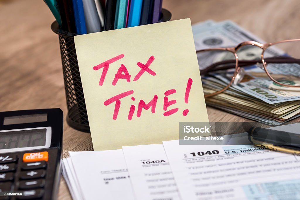 tax form with calculator, money and pen Tax Form Stock Photo