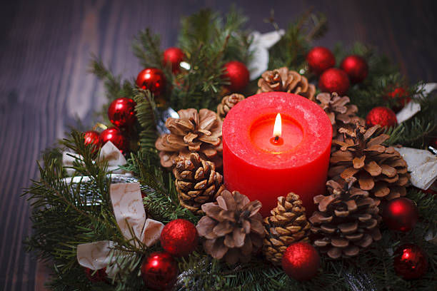 istock Decorated Christmas wreath with a candle close-up 610689024