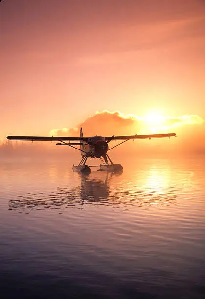 A moored float plane on an autumn dawn on a Canadian lake.