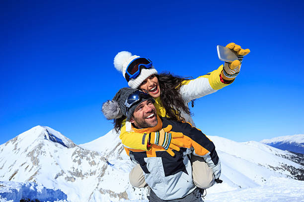 istock Cheerful young couple skiers making winter selfie 610692896