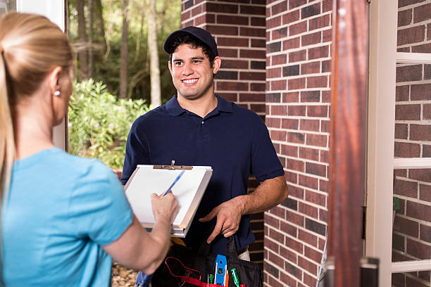 istock Repairman at customer's front door. 610693160