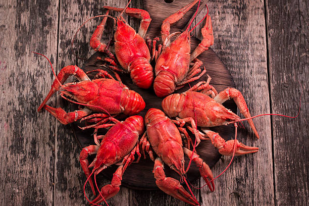 istock fresh boiled crawfish on the old wooden background 610743548