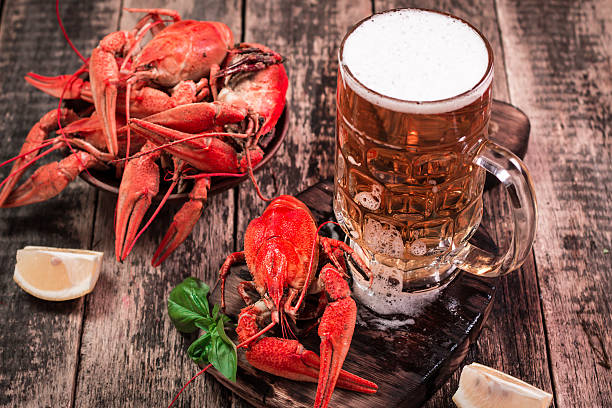 istock boiled crawfish and beer on a wooden background 610744114