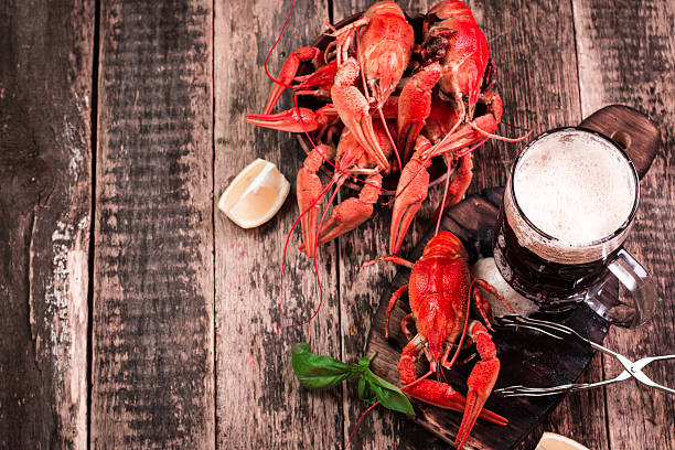 istock boiled crawfish and beer on a wooden background 610744370