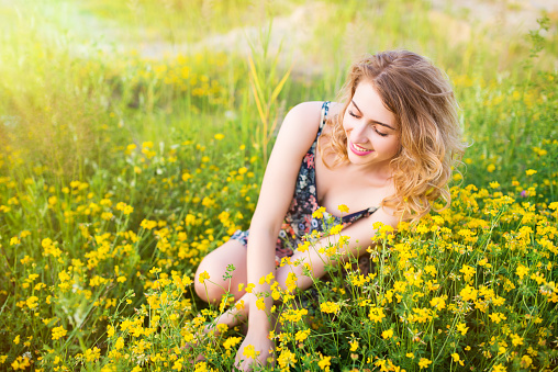 Beautiful woman portrait in flowers field