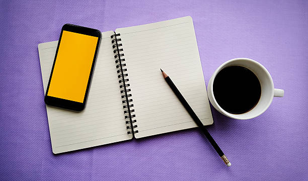 istock Tea in white cup with Journal book and smartphone 610745928