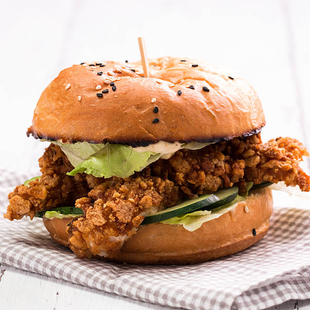 istock Tasty grilled burger with lettuce and mayonnaise , rustic wooden table 610746790