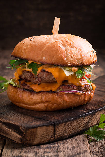 istock Tasty grilled burger with lettuce and mayonnaise , rustic wooden table 610746962