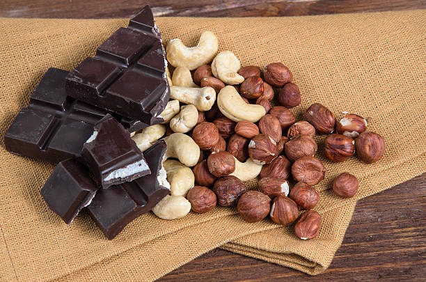 istock Chocolate and nuts with napkin on wood 610747080
