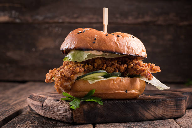 istock Tasty grilled burger with lettuce and mayonnaise , rustic wooden table 610747268