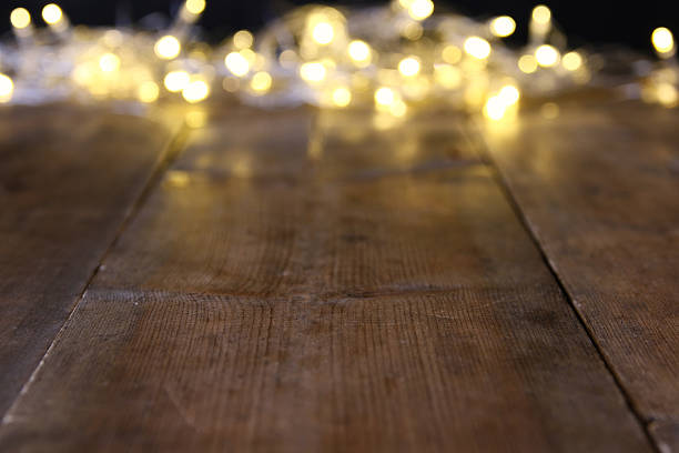 istock Abstract blurred christmas lights on wooden table 610747362