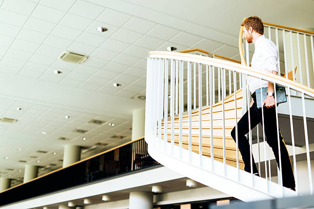istock Business visionary represented by a man climing stairs 610749418
