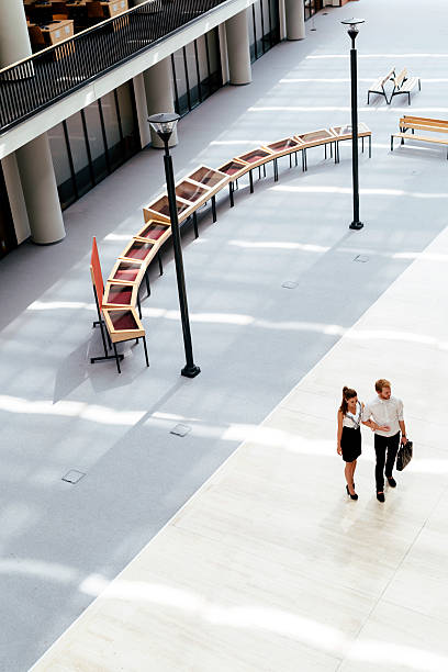 istock Business couple walking together 610750854